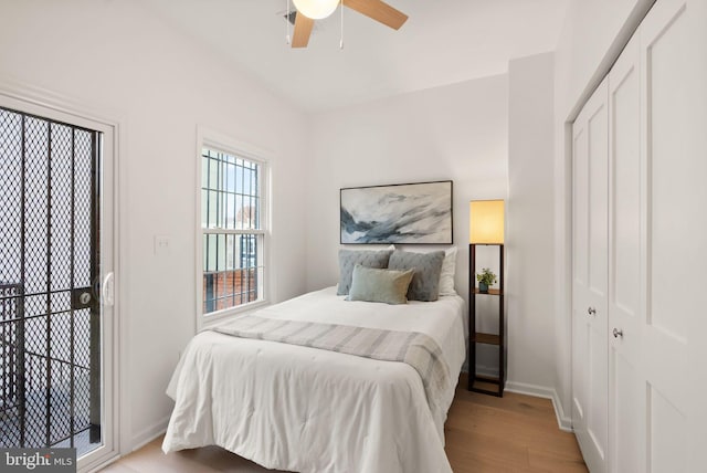 bedroom featuring ceiling fan, light hardwood / wood-style floors, and a closet