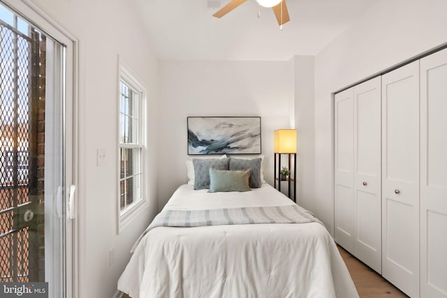 bedroom featuring a closet, ceiling fan, and light wood-type flooring