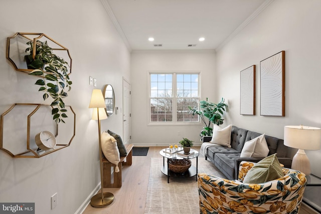 living room with hardwood / wood-style flooring and crown molding