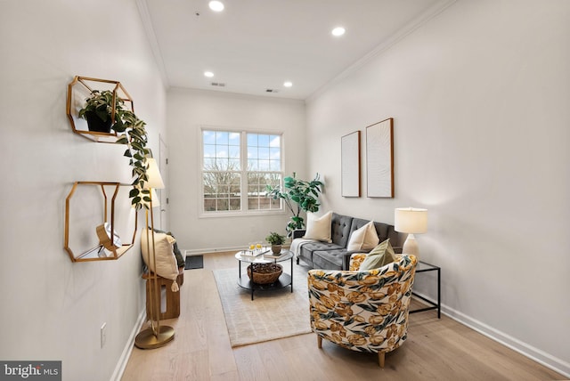 living area with crown molding and light wood-type flooring