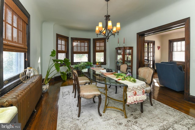 dining space featuring a chandelier and dark hardwood / wood-style floors