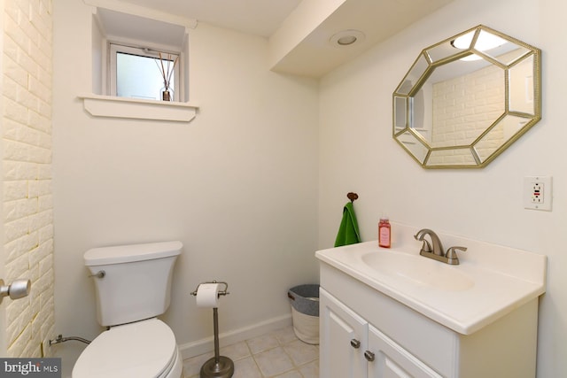 bathroom featuring tile patterned flooring, vanity, and toilet