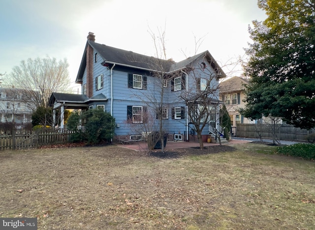 back of house featuring a yard and a patio