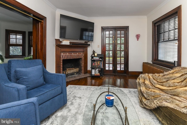 living room featuring french doors, a healthy amount of sunlight, dark hardwood / wood-style floors, and ornamental molding