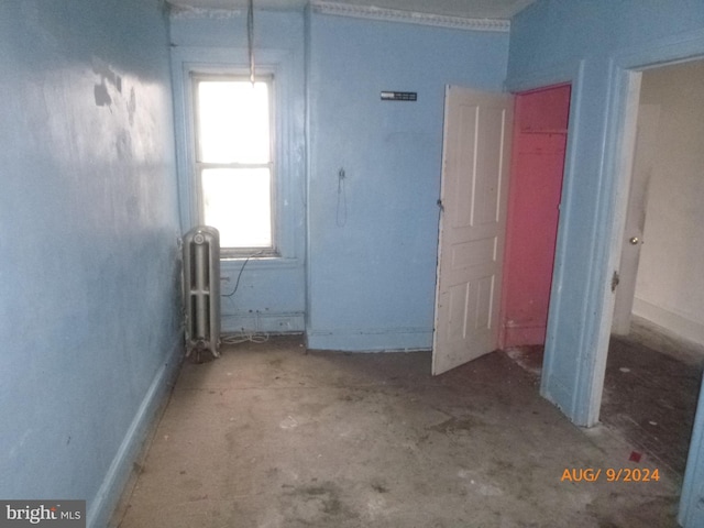 interior space featuring radiator heating unit and concrete floors