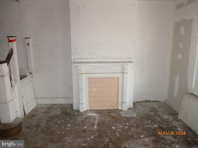 unfurnished living room featuring radiator heating unit