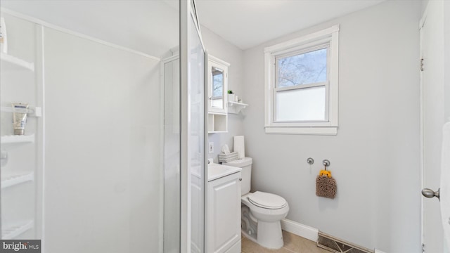 bathroom with tile patterned flooring, vanity, toilet, and a shower