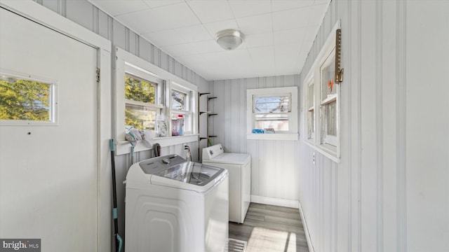 washroom with dark hardwood / wood-style flooring, plenty of natural light, and independent washer and dryer