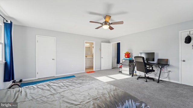 bedroom featuring connected bathroom, light colored carpet, and ceiling fan