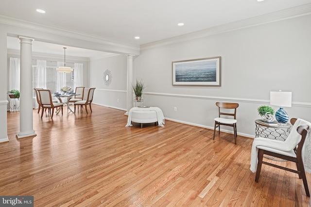 living area featuring ornamental molding, light wood-style flooring, decorative columns, and baseboards