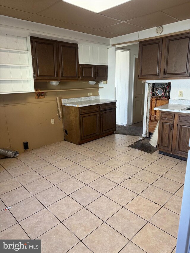 kitchen featuring dark brown cabinets and light tile patterned floors