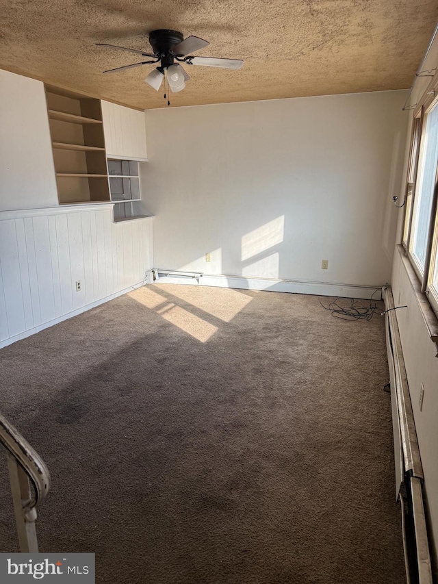 unfurnished room with ceiling fan, carpet floors, and a textured ceiling