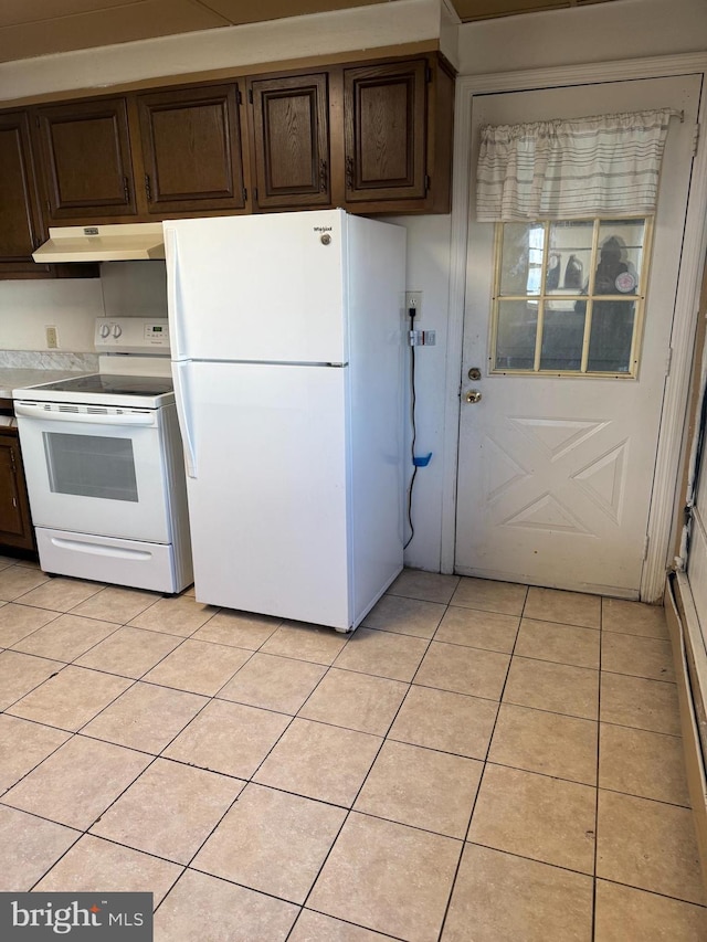 kitchen with light tile patterned floors, white appliances, and dark brown cabinets