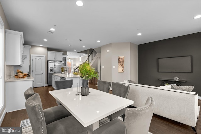 dining space with dark wood-type flooring and sink