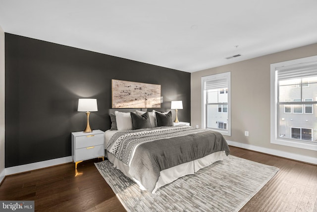 bedroom with dark wood-type flooring