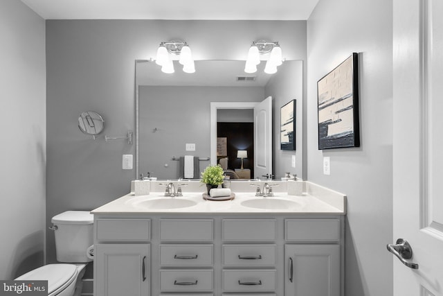 bathroom featuring vanity and toilet