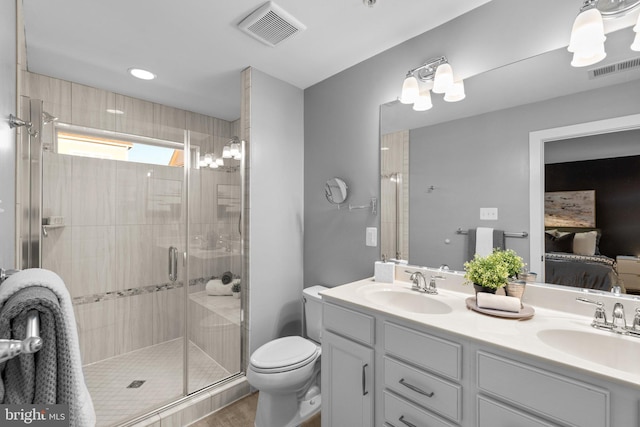 bathroom featuring toilet, an enclosed shower, and vanity