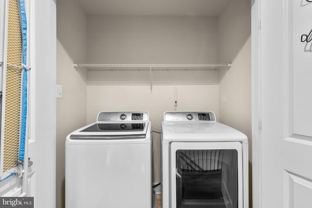 clothes washing area with independent washer and dryer