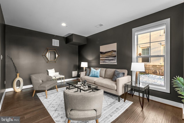 living room with plenty of natural light and hardwood / wood-style flooring