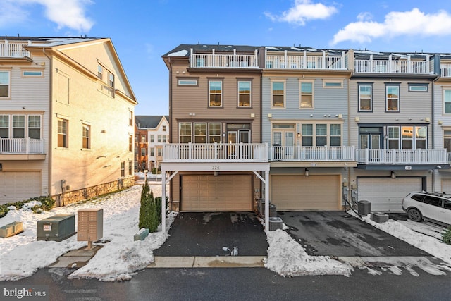 view of front of property featuring central AC and a garage