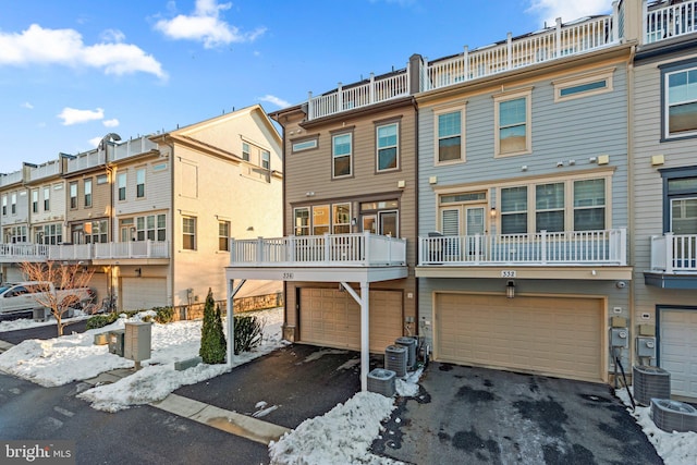 snow covered property featuring central AC unit