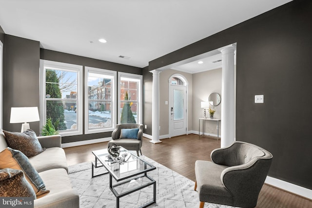 living room featuring hardwood / wood-style floors and decorative columns