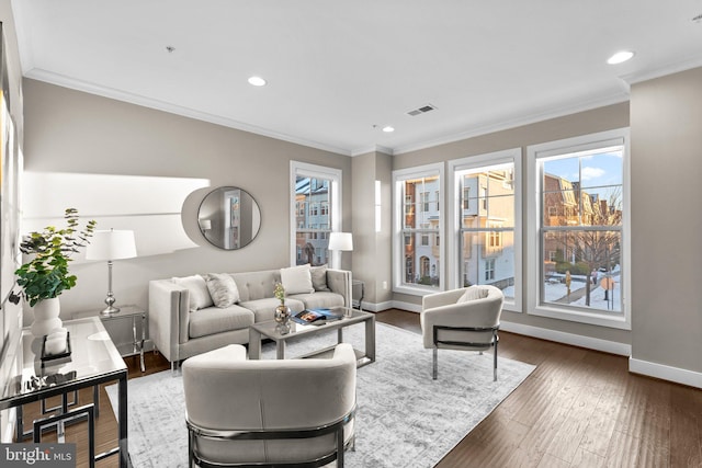 living room featuring ornamental molding, dark hardwood / wood-style flooring, and plenty of natural light