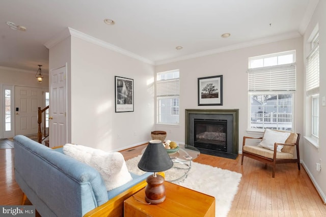 living room with crown molding and plenty of natural light