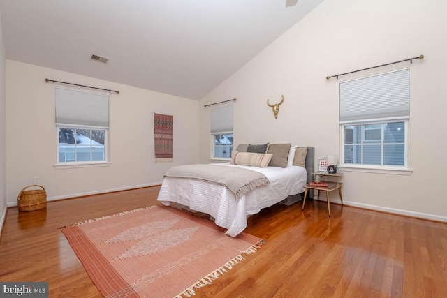 bedroom featuring wood-type flooring and vaulted ceiling