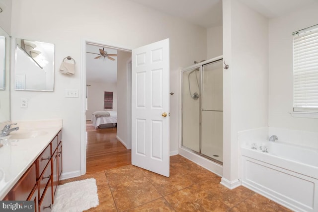 bathroom with separate shower and tub, ceiling fan, and vanity