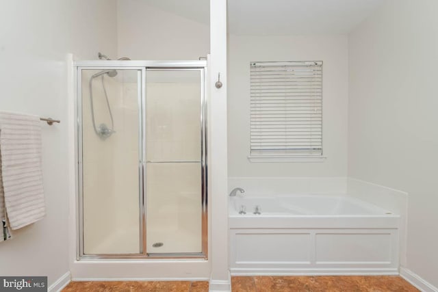 bathroom featuring separate shower and tub