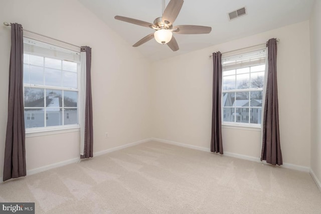 carpeted spare room with ceiling fan and lofted ceiling