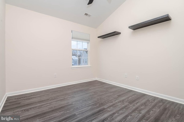 empty room featuring lofted ceiling, ceiling fan, and dark wood-type flooring