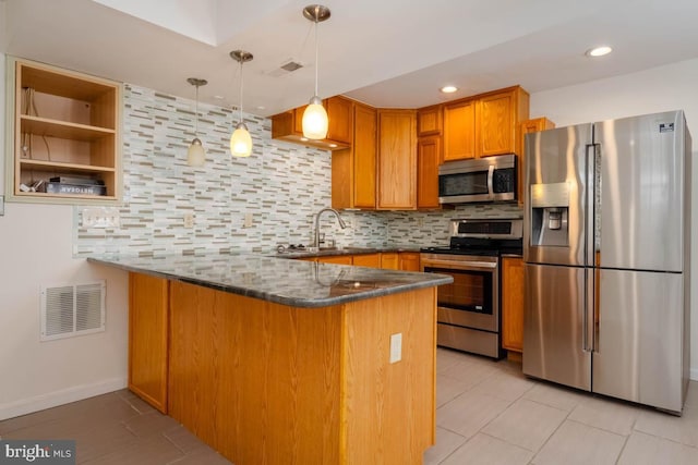 kitchen featuring dark stone counters, decorative backsplash, light tile patterned flooring, kitchen peninsula, and stainless steel appliances