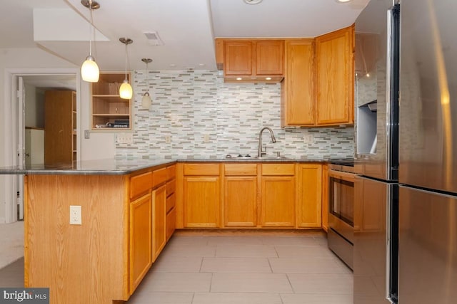 kitchen with pendant lighting, sink, tasteful backsplash, kitchen peninsula, and stainless steel appliances