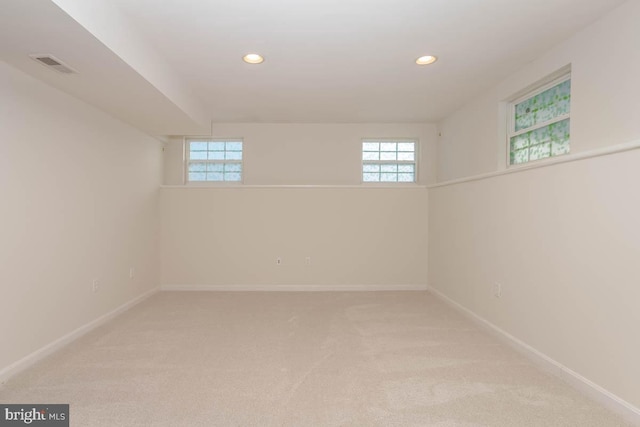 basement featuring light colored carpet