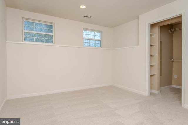 basement featuring light colored carpet