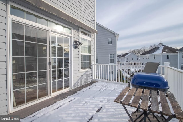 snow covered patio with a deck