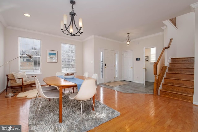 dining room featuring a chandelier, hardwood / wood-style floors, and crown molding