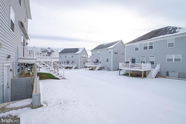 snowy yard with a deck