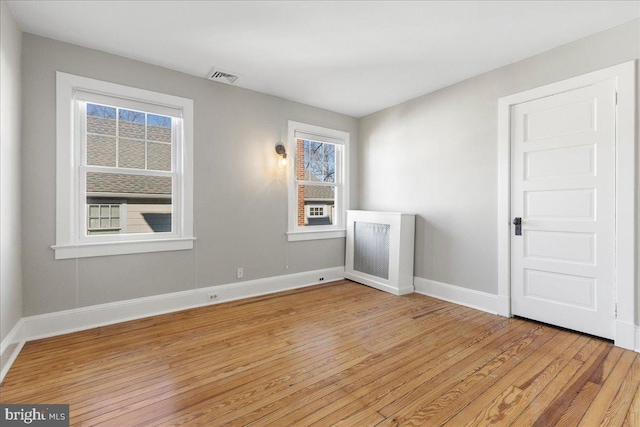 spare room featuring light hardwood / wood-style flooring