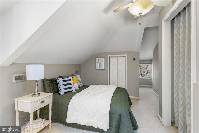 carpeted bedroom featuring lofted ceiling, a closet, and ceiling fan