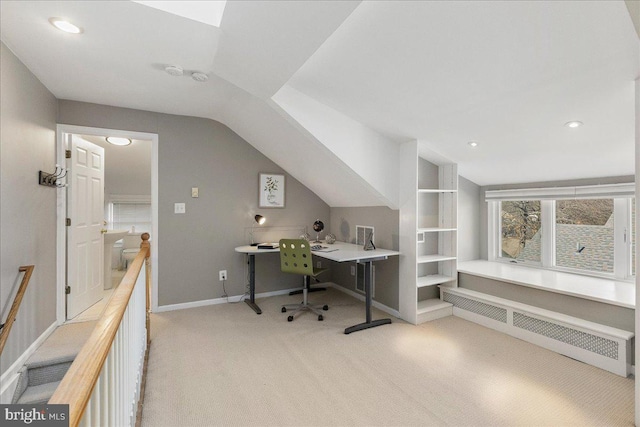 office with lofted ceiling, light carpet, and radiator heating unit