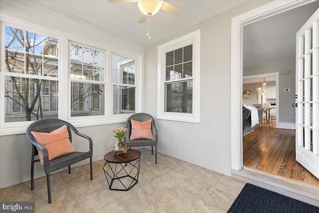 sunroom featuring ceiling fan