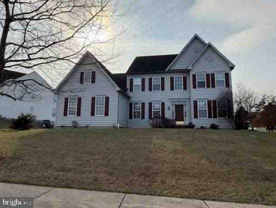 colonial inspired home with a front yard