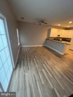 unfurnished living room with wood-type flooring