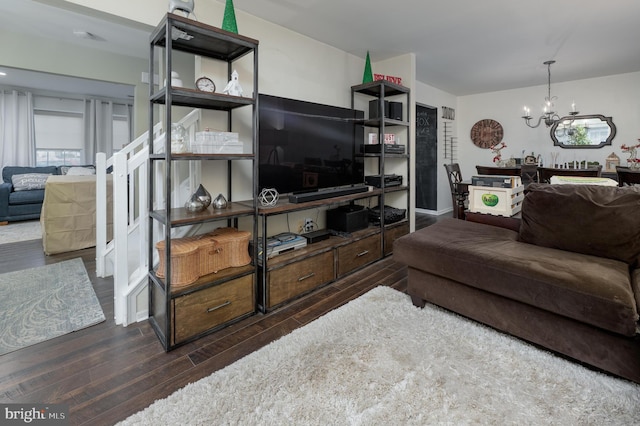 living room featuring dark hardwood / wood-style flooring and a notable chandelier