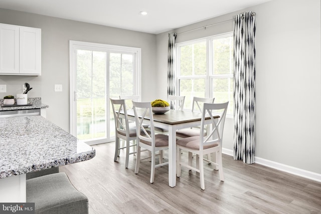 dining space featuring light wood-type flooring