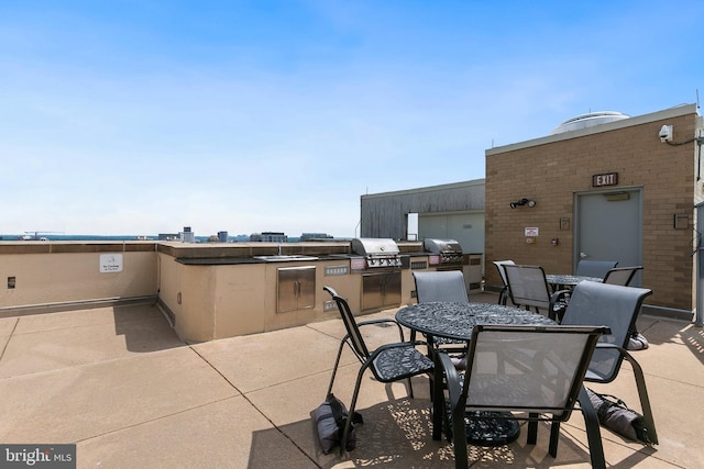 view of patio featuring area for grilling, exterior kitchen, and sink