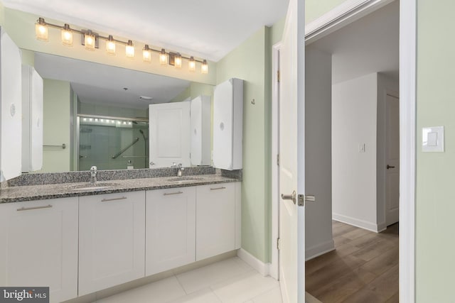 bathroom featuring an enclosed shower and vanity